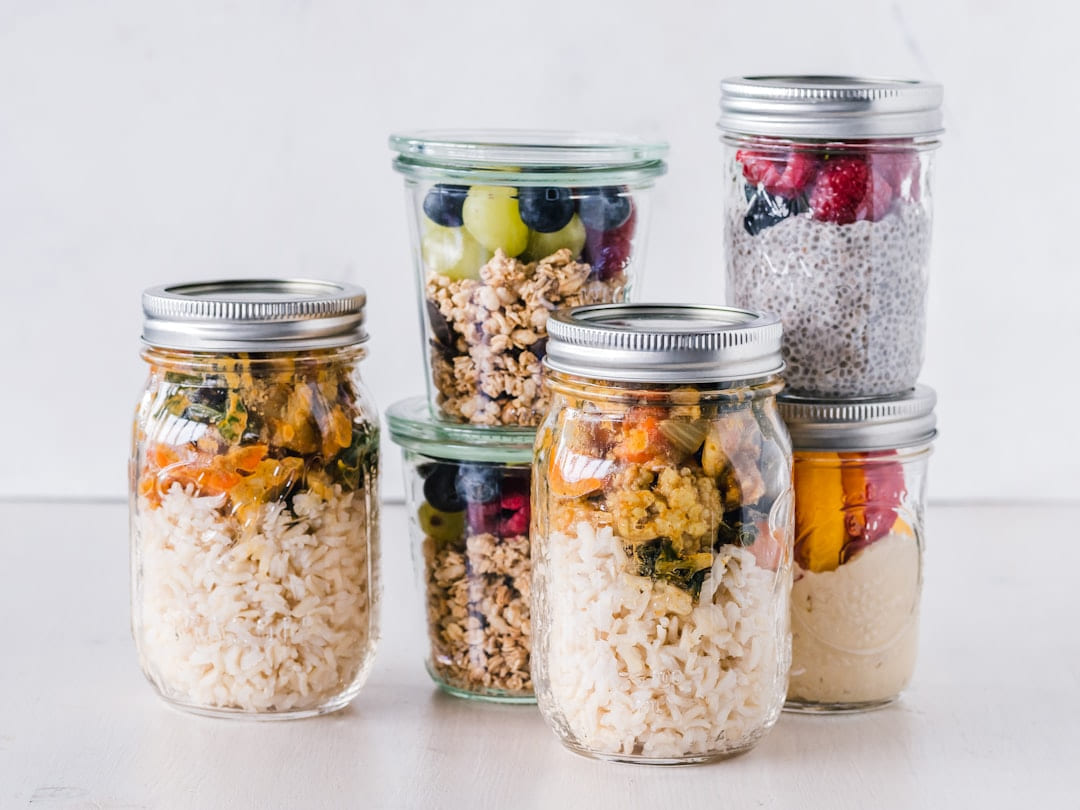 six full clear glass jars on white surface on Earth Wise Budget