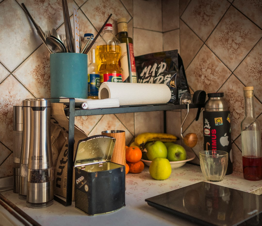 Kitchen counter with fruit, spices, and utensils. on Earth Wise Budget