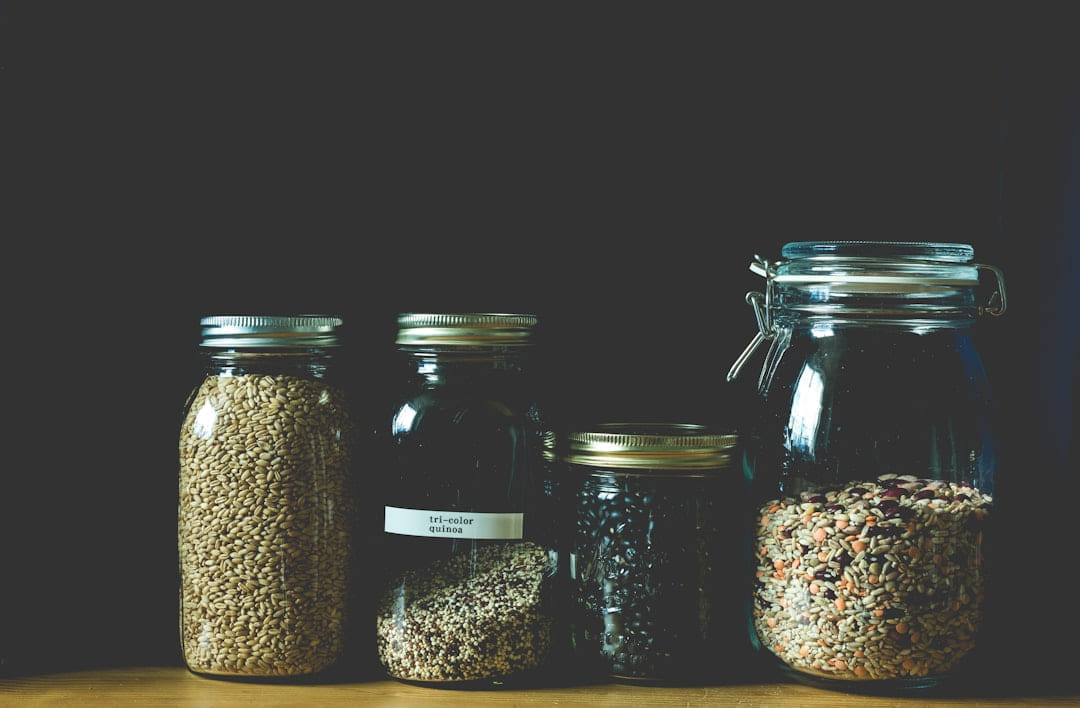 four clear jars filled with grains on Earth Wise Budget