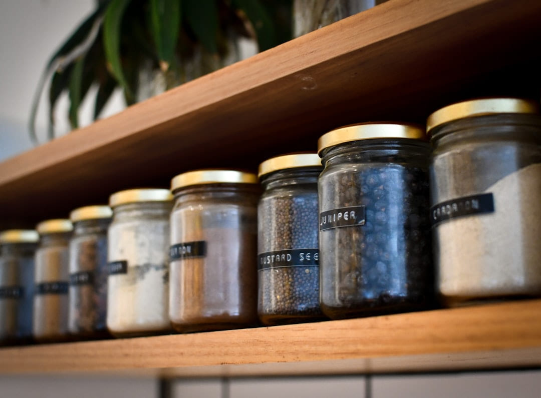 a shelf filled with lots of different types of spices on Earth Wise Budget