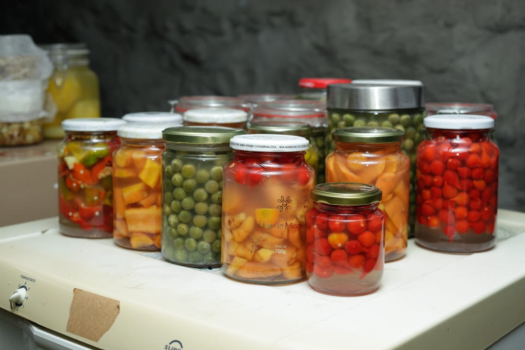 Jars of preserved vegetables and fruits on a shelf. on Earth Wise Budget
