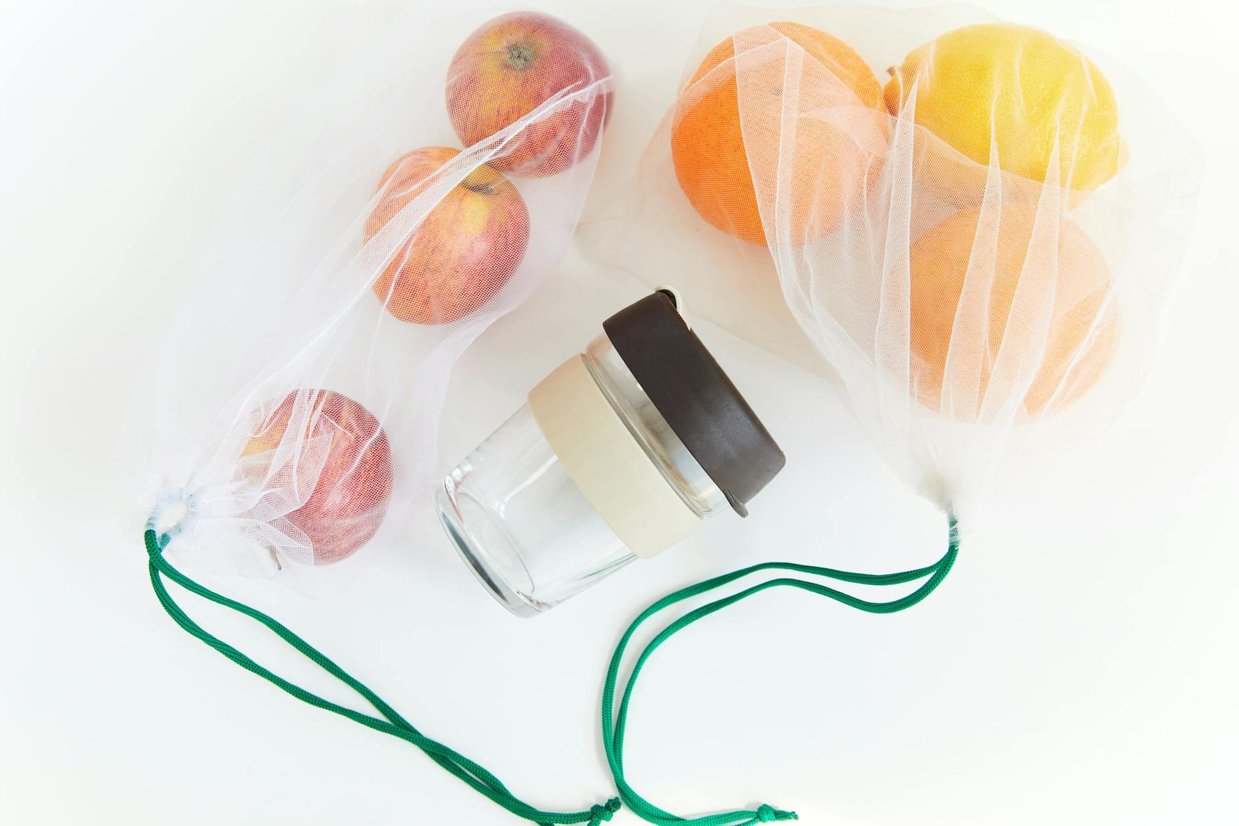 Sustainable lifestyle with reusable mesh bags and a jar on a white background. on Earth Wise Budget