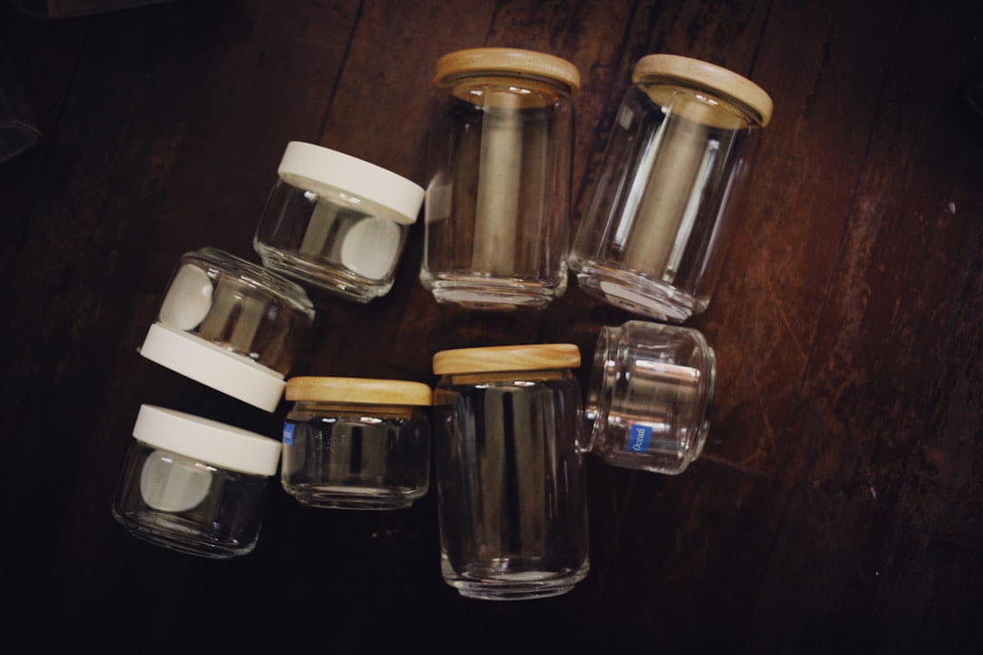 a group of glass jars sitting on top of a wooden table on Earth Wise Budget