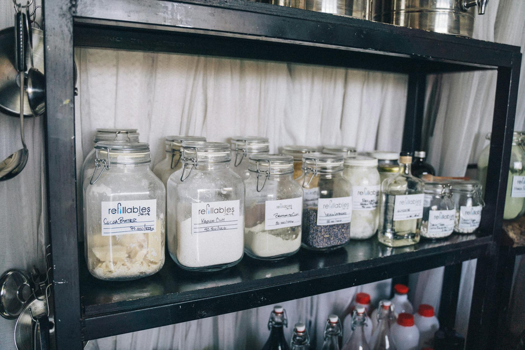 Organized glass jars on a pantry shelf for eco-friendly food storage and sustainability. on Earth Wise Budget