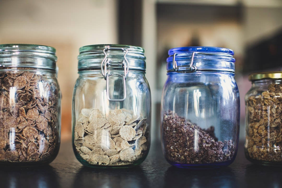 four glass jars filled with different types of food on Earth Wise Budget