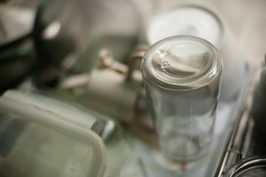 Close-up of an empty glass bottle on a shelf. on Earth Wise Budget
